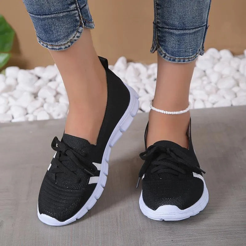 Women's lace-up mesh trainers with flat rubber sole, round toe and shallow mouth, shown in grey, black, orange and brown
