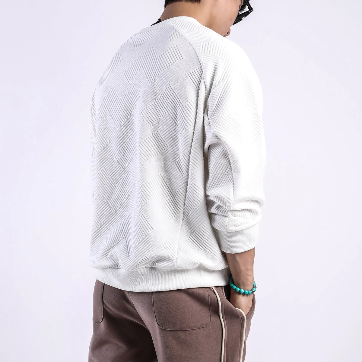 Men's loose fit twill Jacquard pullover sweater in army green, shown on a model.