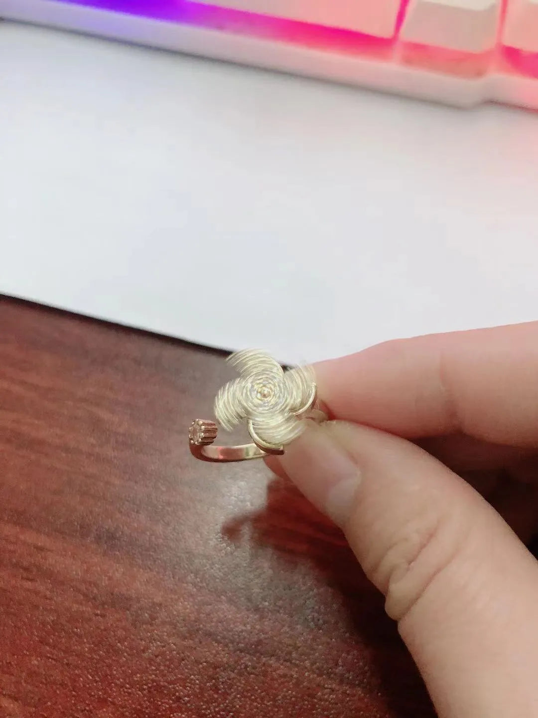 Rotating ring with spinning windmill design and micro inlaid geometry pattern in gold electroplated finish