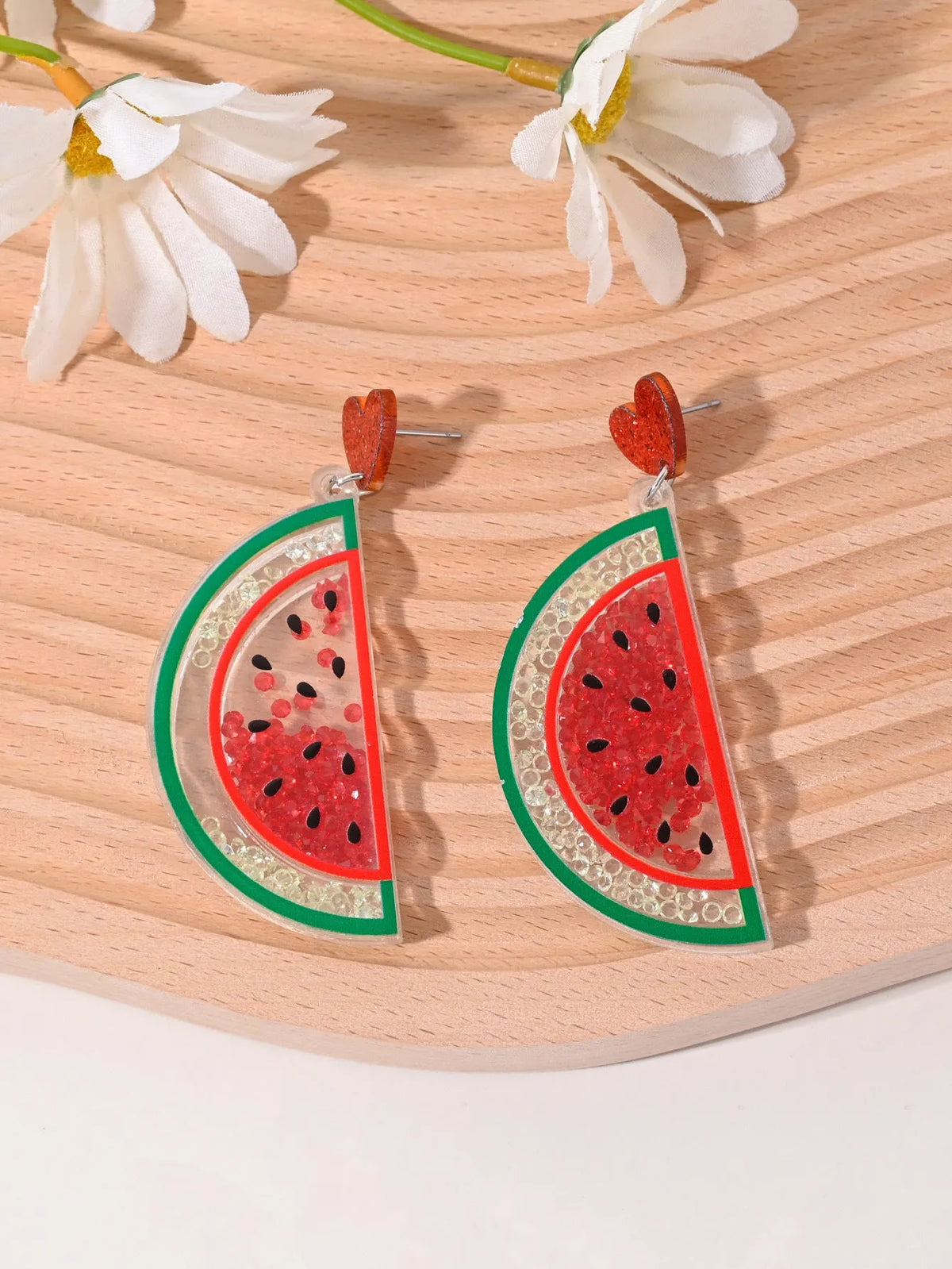Acrylic drop earrings shaped like a strawberry, cherry, watermelon, pineapple, cake, ice cream, and coconut tree on a white background.