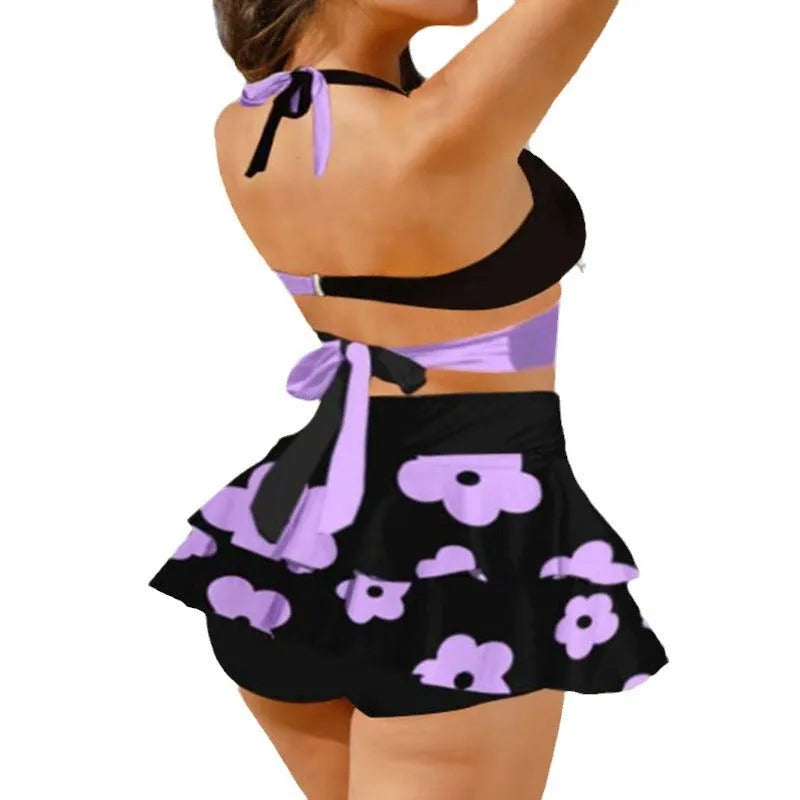 Women's purple high-waisted bikini swimsuit with lace-up detail and skirt