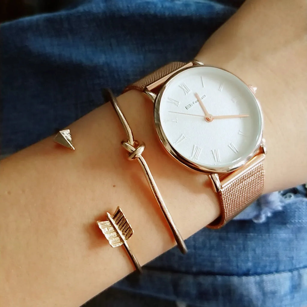 Gold women's cuff bracelet with arrow knot design on alloy electroplated band