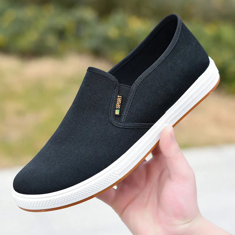 Men's black and blue canvas slip-on shoes with shallow cut design and composite soles