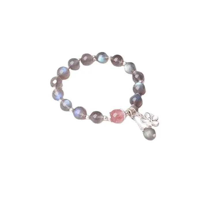 Women's bracelet with pink strawberry quartz and grey moonstone beads on a sterling silver chain with a charm.