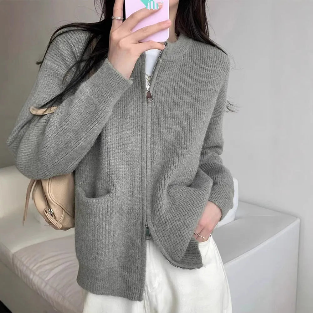 Beige soft viscose women's sweater coat cardigan with long sleeves on a hanger.