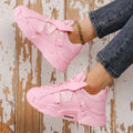 Women's purple platform sneakers with breathable mesh upper and white sole on a plain background.
