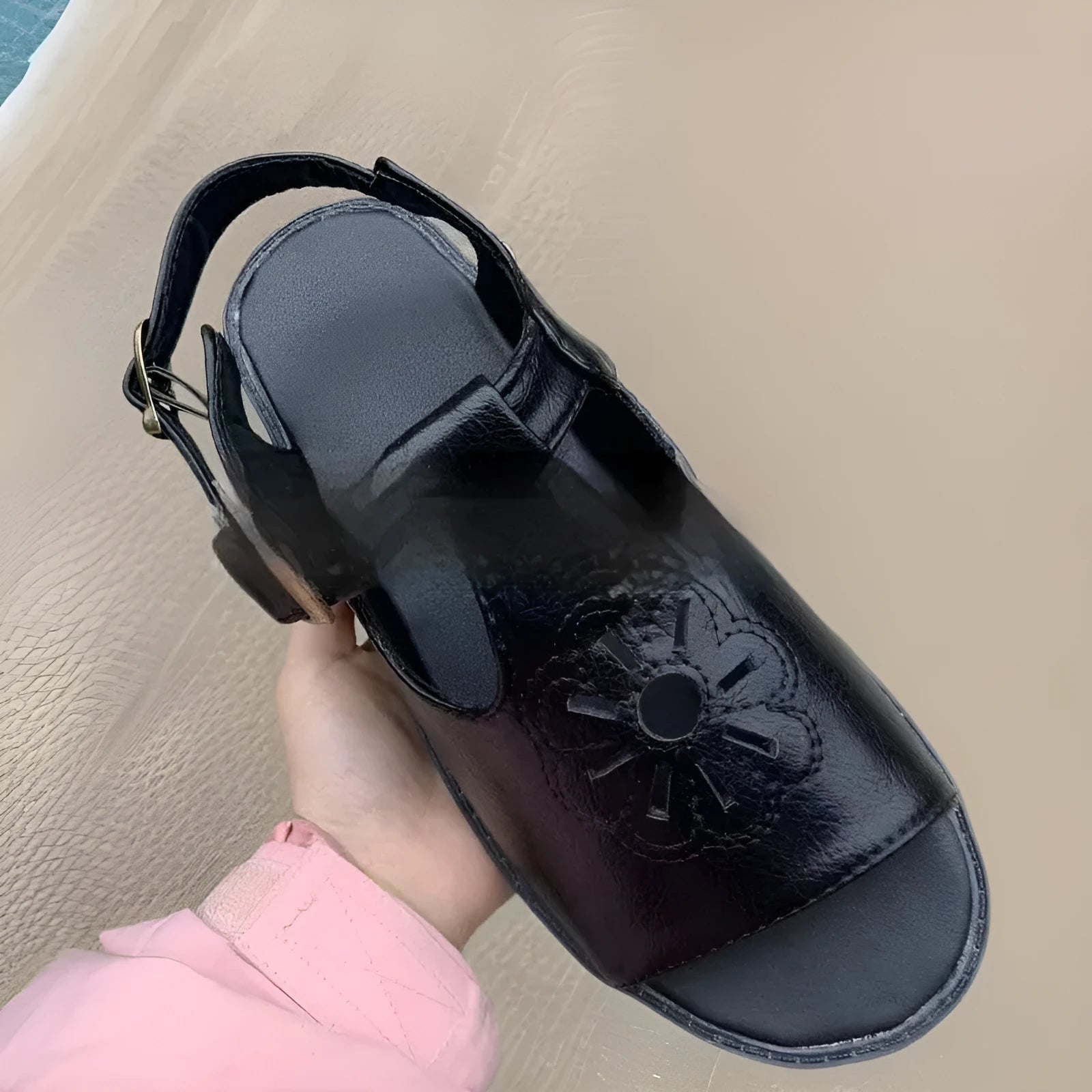 Men's black embroidered floral pattern beach sandals with flat heel on a neutral background