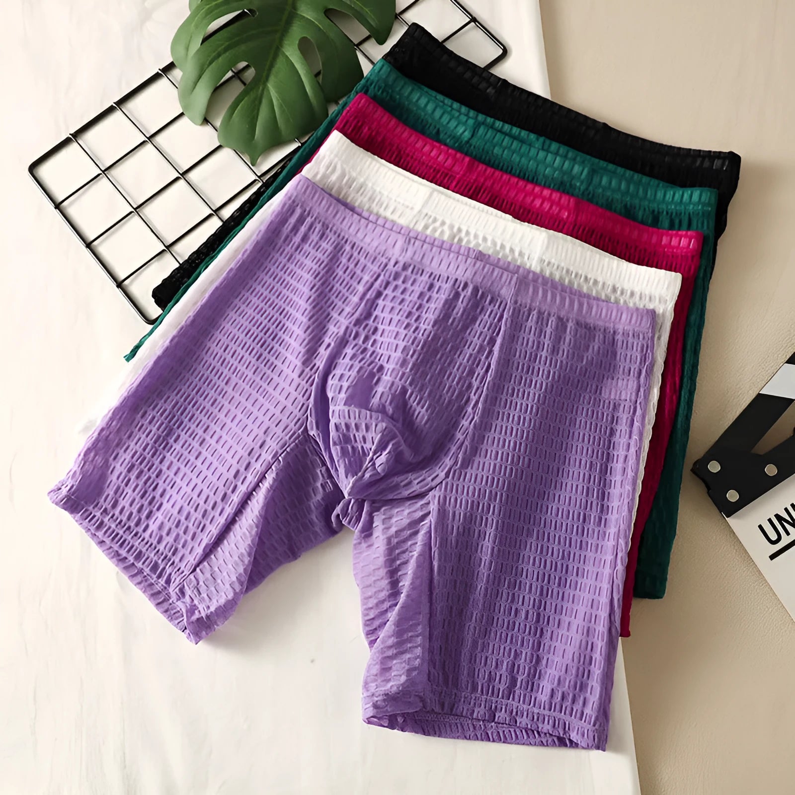Men's solid colour lace boxer shorts in a hip-lifting, lengthened shaping style on a white background.