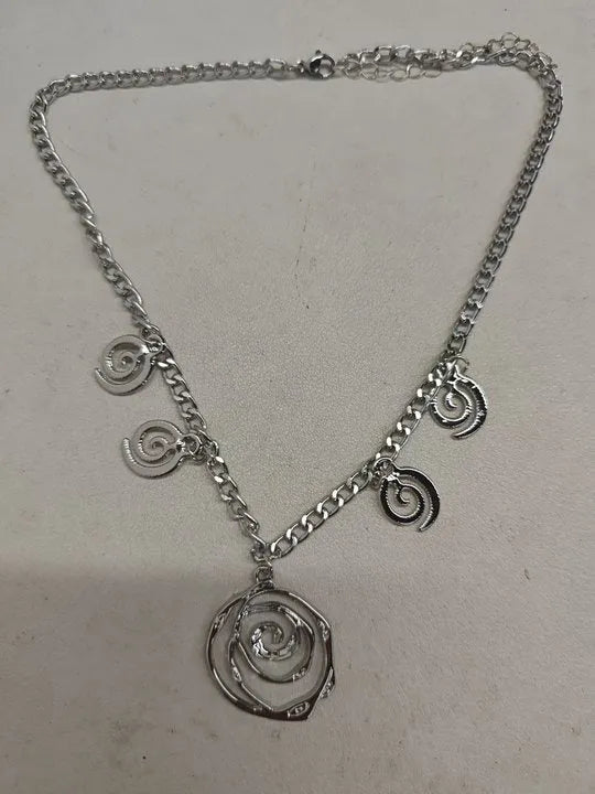 Spiral donut jewellery set showing necklace, bracelet, and earrings in geometric circle design with gold electroplated finish