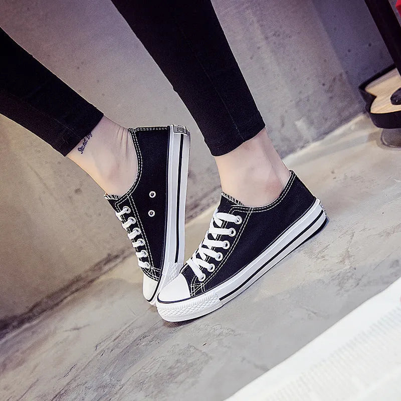 Women's solid colour canvas casual shoes showing available colours: all-black, black, white-black, and white-red.