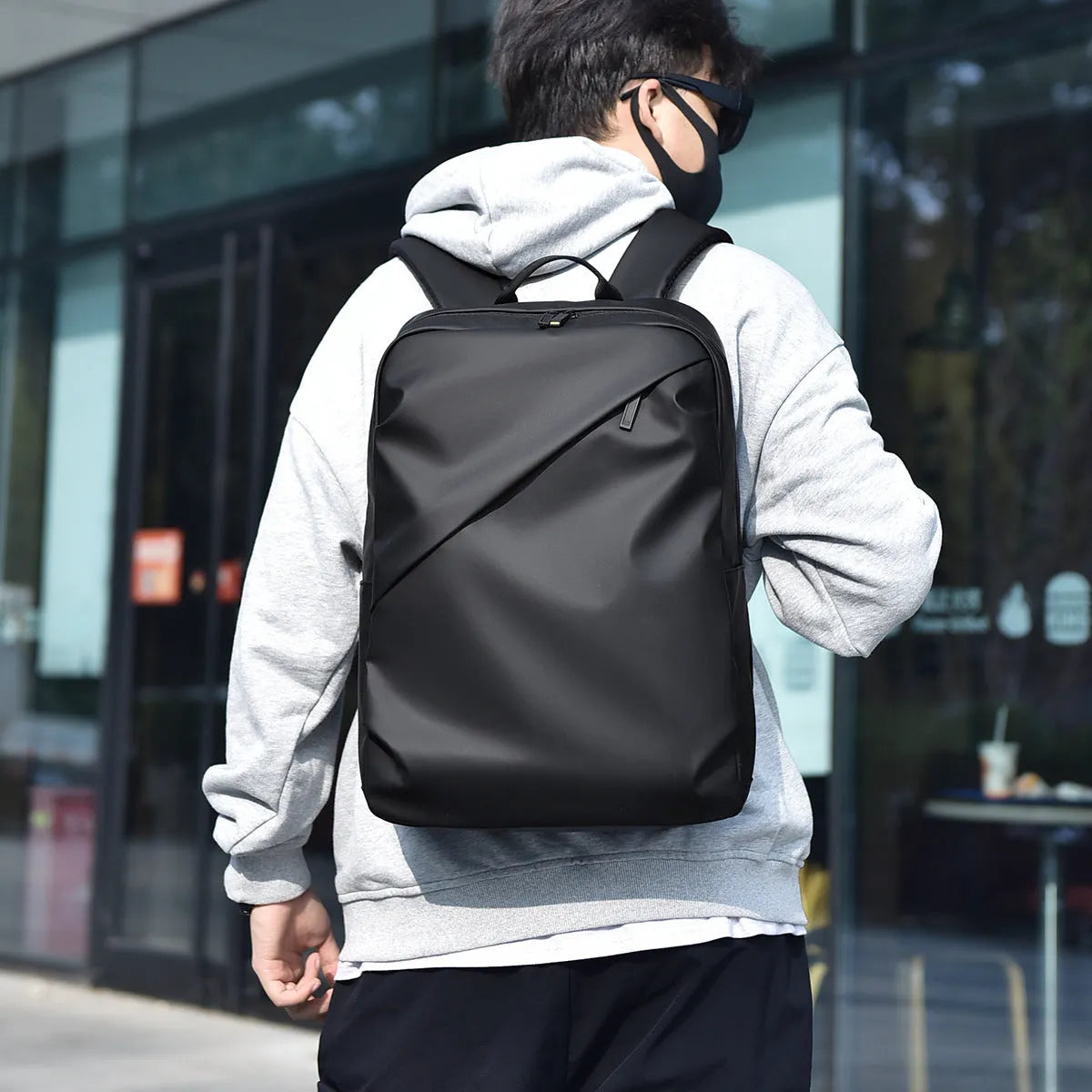 Waterproof PU leather backpack in black with contrast stitching and large capacity design