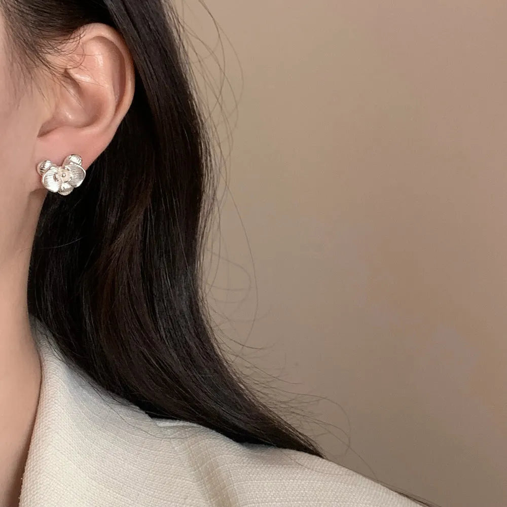 Women's retro floral copper earrings with electroplated gold or silver finish showing petal flower design
