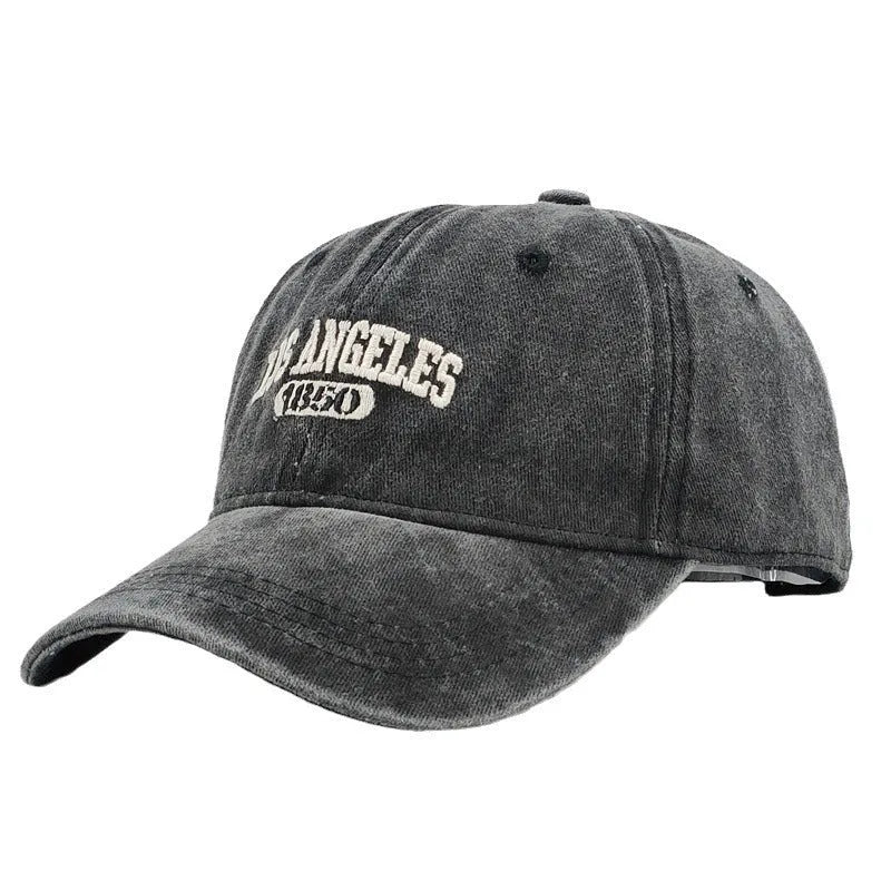 Personalised washed distressed embroidered peaked cap in acrylic fabric on adjustable head model.