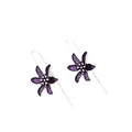 Close-up of a pair of purple flower-shaped alloy stud earrings with an electroplated finish.