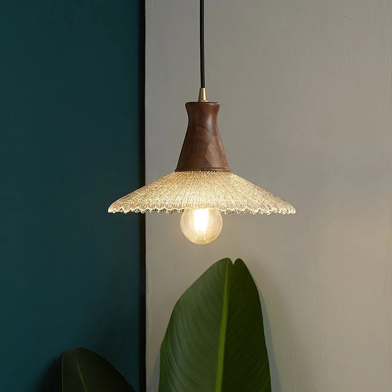 Retro wooden ceiling lamp with brass details and glass shade shown in a dining setting