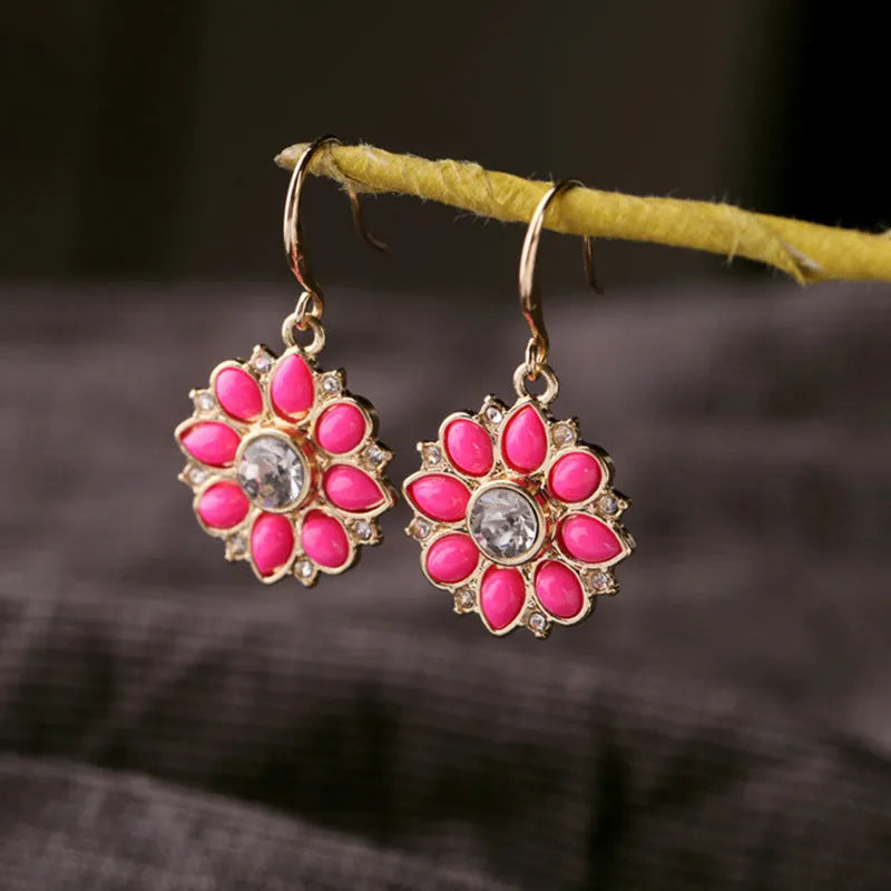 Pair of alloy flower-shaped earrings with artificial gemstone inlay, available in blue or red for women