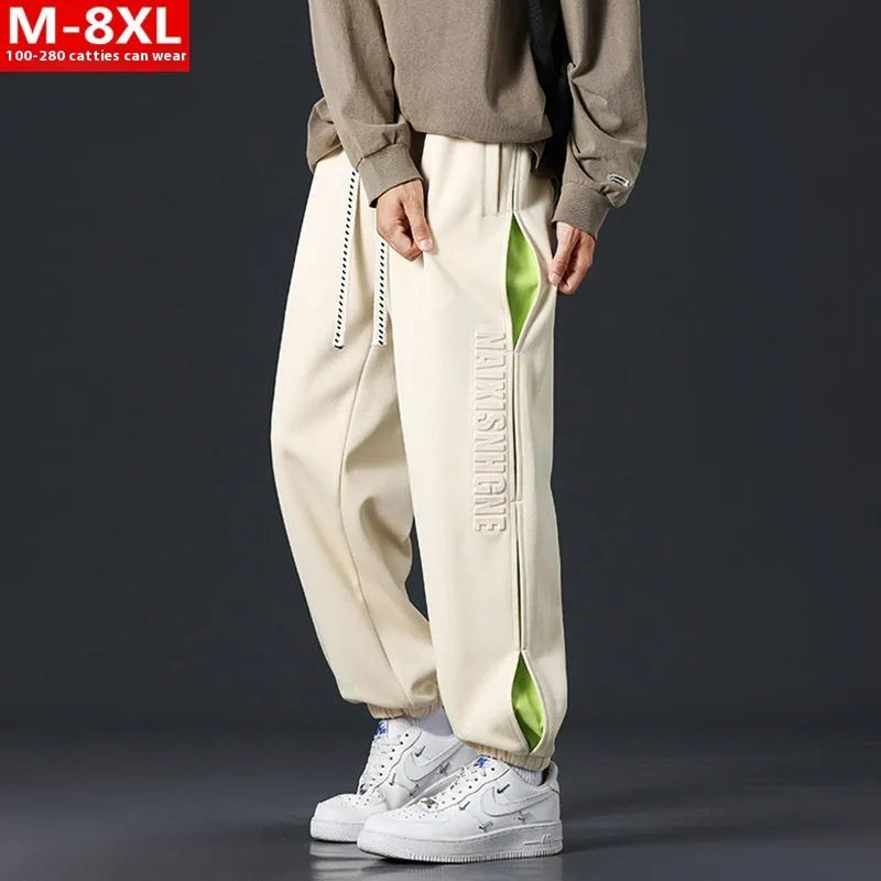 Men's loose-fit cotton trousers with stitching print design and ankle band in grey green.