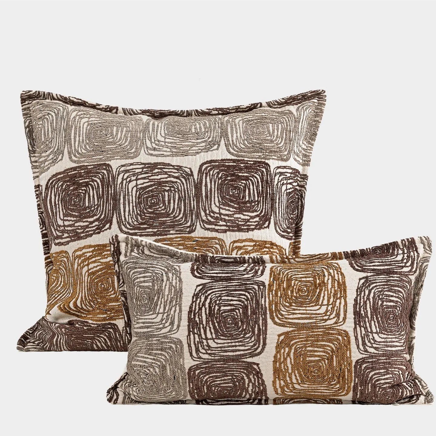 Square and rectangular decorative cushion covers with an abstract coil pattern in cream and coffee brown colours.