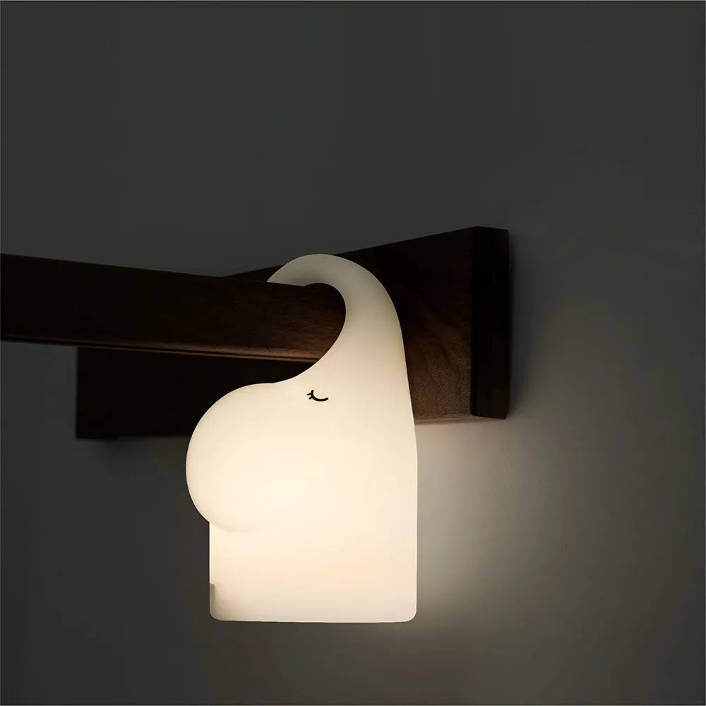 DOMI Elephant Silicone Night Light with warm LED lighting on bedside table