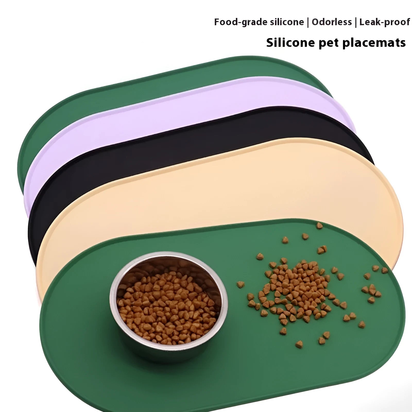 Green silicone cat feeding placemat with food and water bowls on top on a wooden floor.