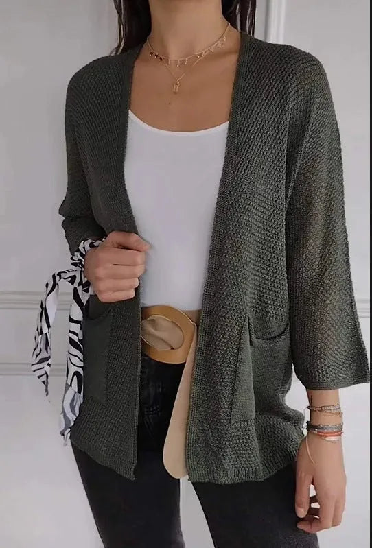 Women's army green waffle texture cardigan coat with nine-quarter sleeves and pockets on a hanger.