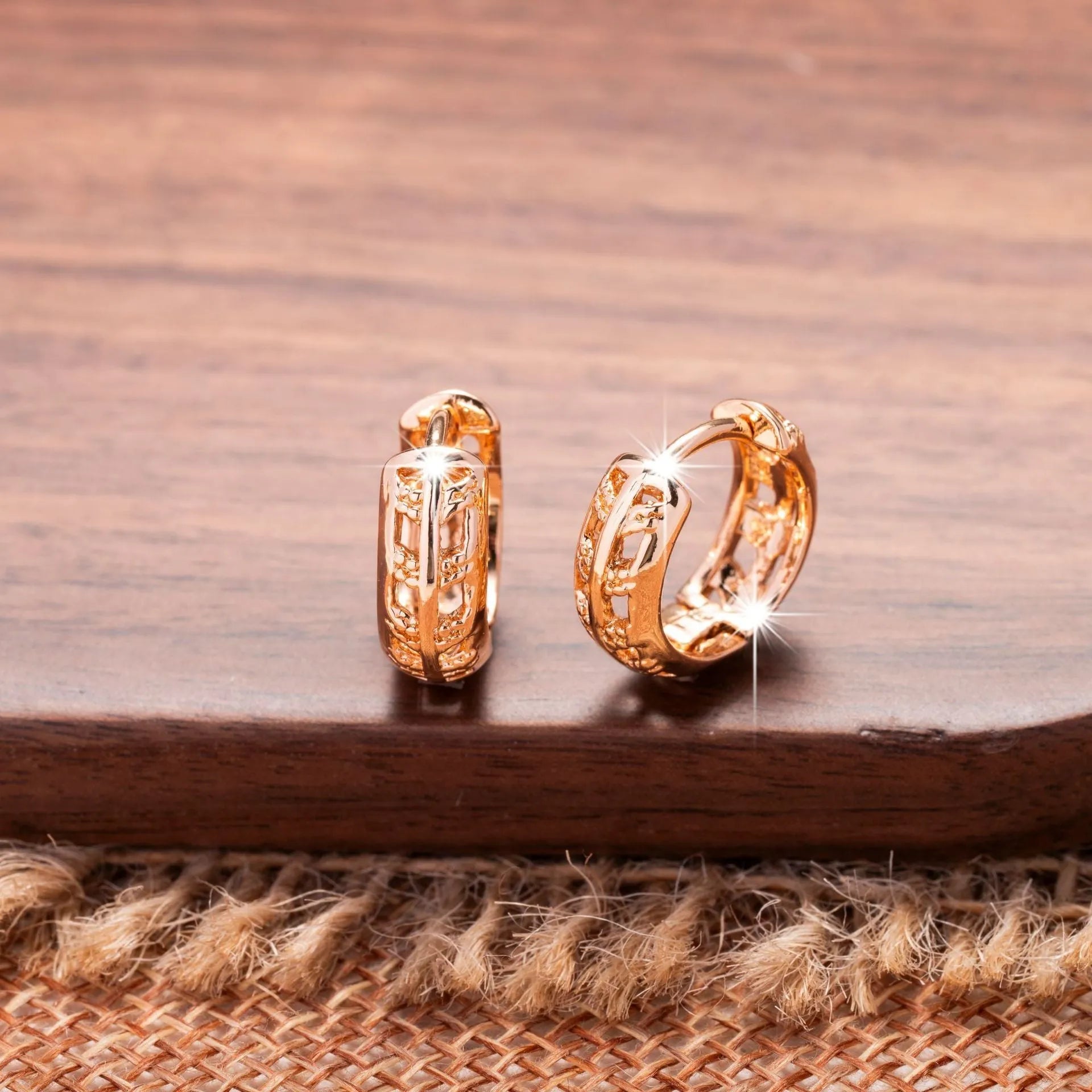 Rose gold coloured hollowed out copper earrings featuring a leaf and heart shape design.