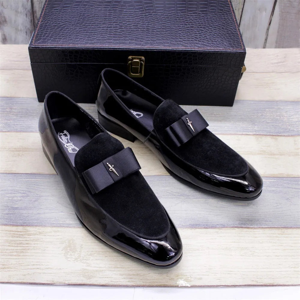 Men's black leather shoes with patent leather finish and a decorative tassel on the front.