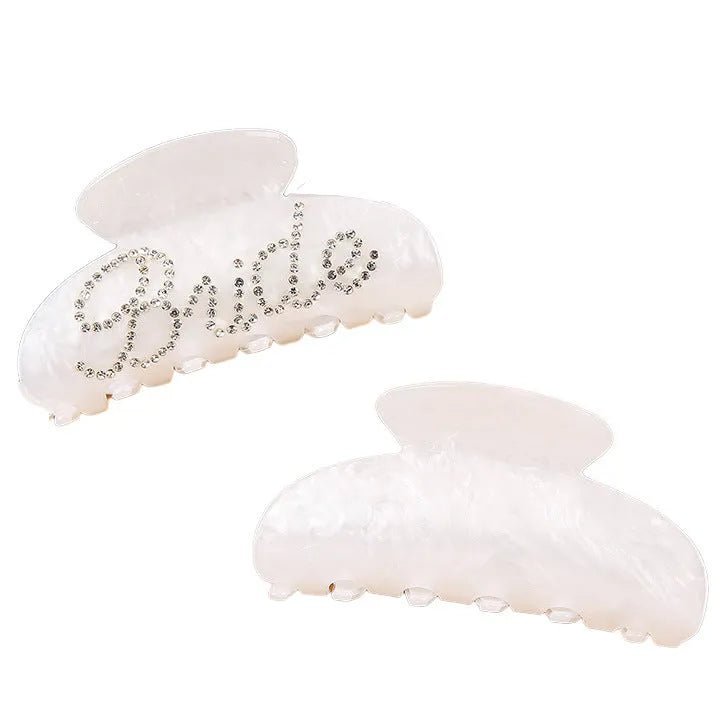 Pink and white acrylic shower shark hair clips with diamond embellishments and English letter details