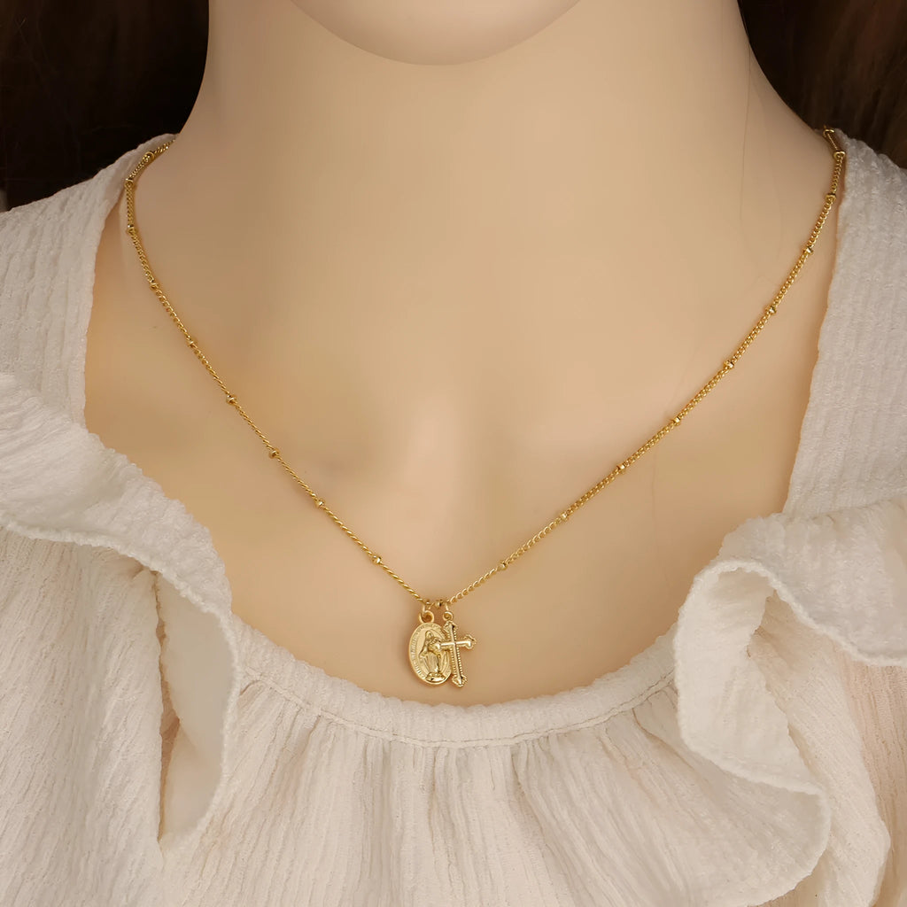 Gold geometric cross necklace with Virgin Mary ornament on chain