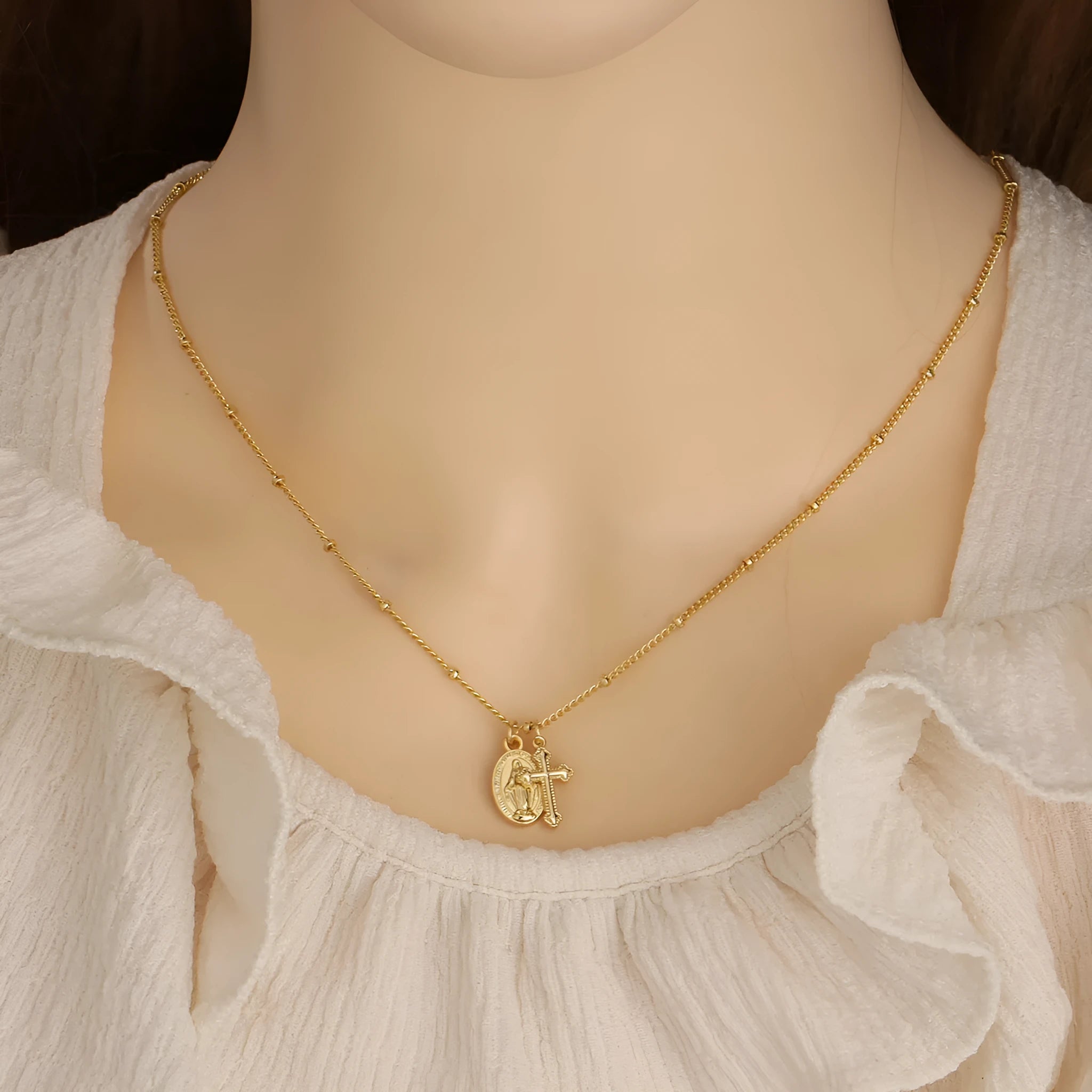 Gold geometric cross necklace with Virgin Mary ornament on chain