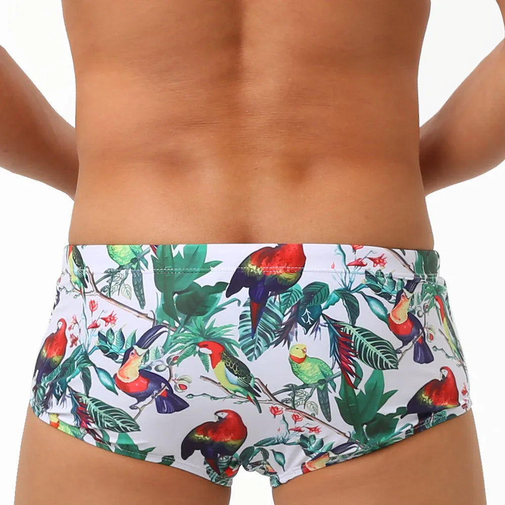 Men's swimming trunks with a colourful floral and bird print, shown in briefs and boxers styles.