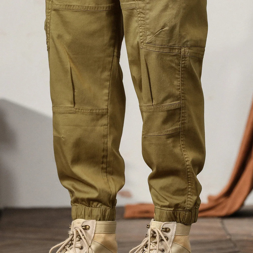 Men's loose-fit cotton harem pants in a solid colour with ankle bands and a mid waist.
