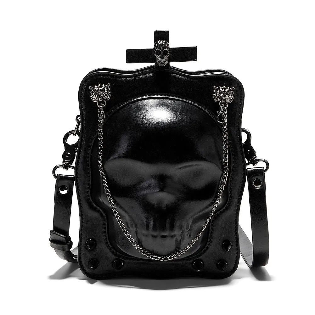 Black gothic mini square messenger bag with skull embossing, stitching, rivets, and chain details on textured PU polyester