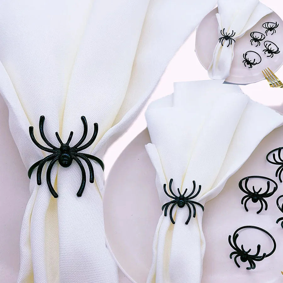 Six black alloy spider-shaped napkin rings for Halloween table decoration.