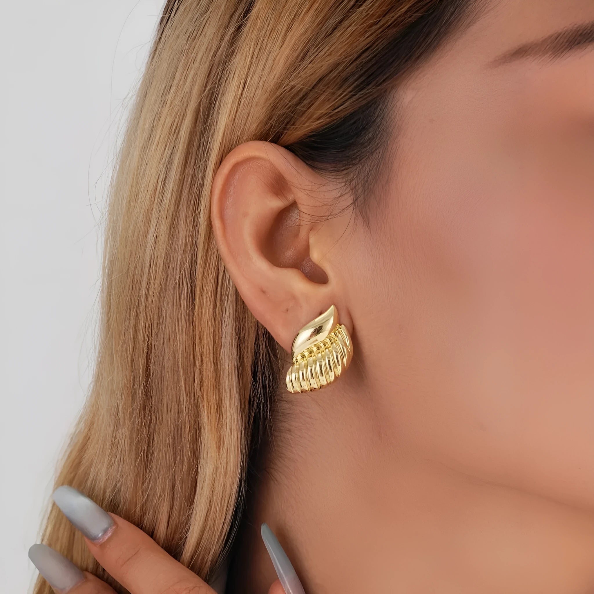 Pair of gold threaded water drop earrings for women on white background