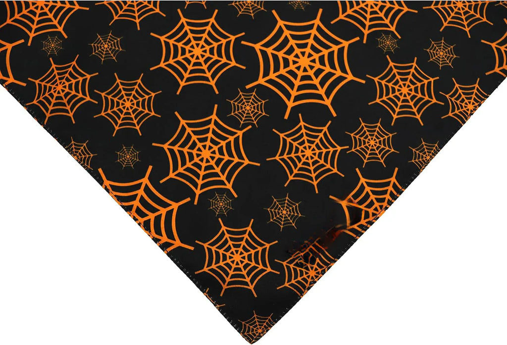Black and orange reversible Halloween dog bandana showing pumpkin and spider web patterns with adjustable neck closure