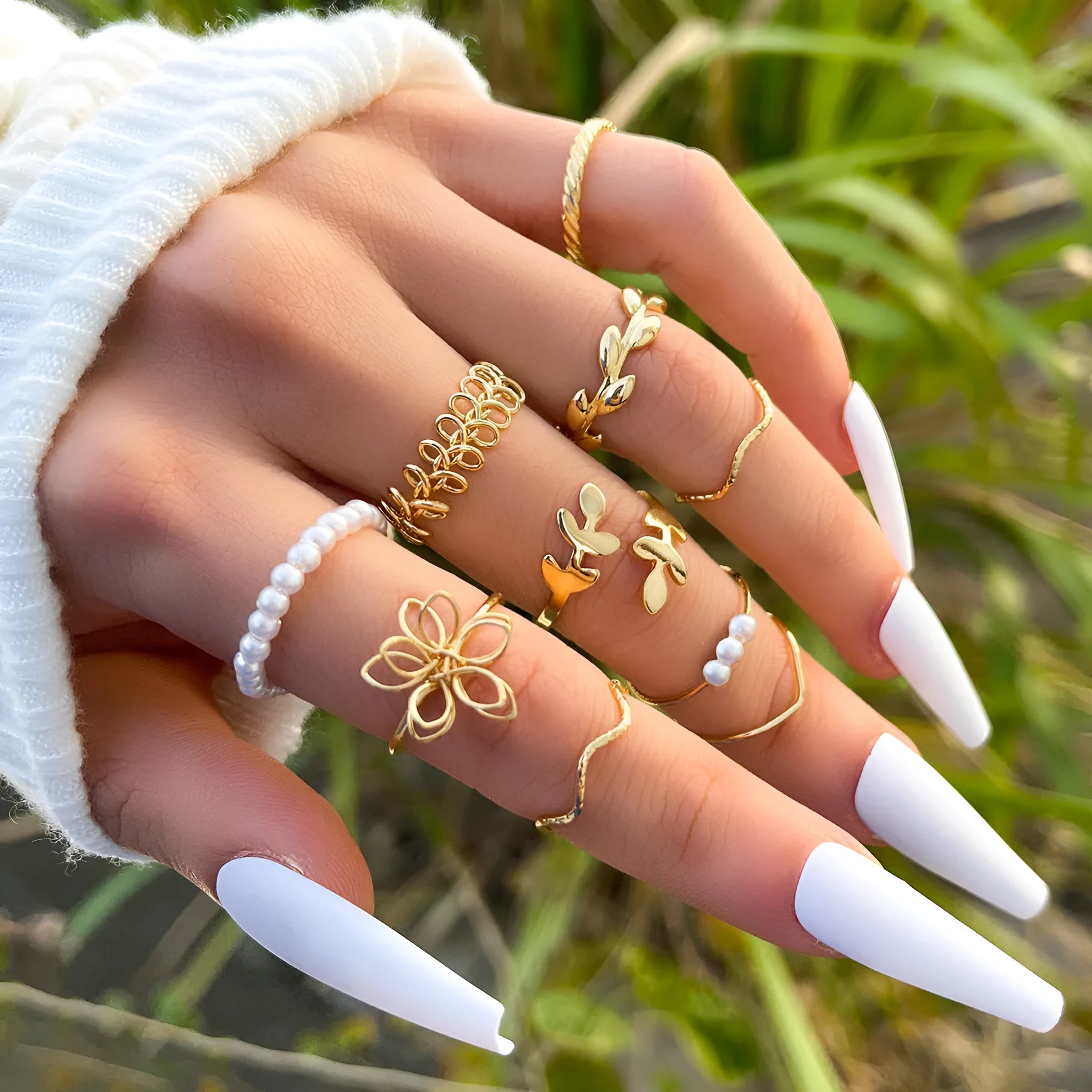 Gold coloured openwork flower design ring for women on a white background.