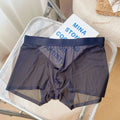 Men's thin grey seamless boxer shorts laid flat, showing knitted nylon fabric and mid-waist design.