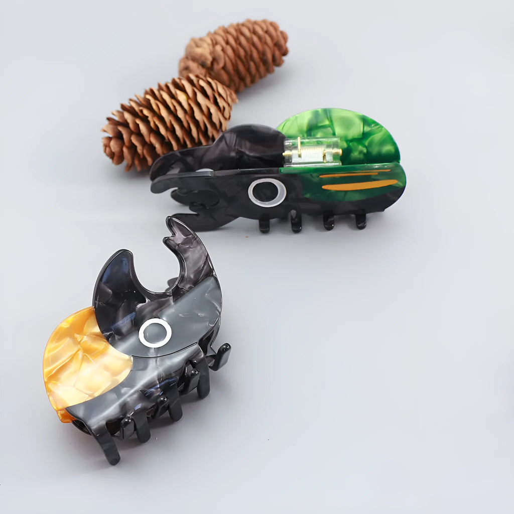 Handmade cartoon beetle grip brooch made from cellulose acetate in green, orange, or white insect designs.