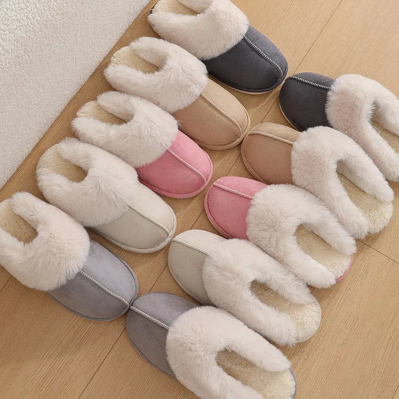 Women's plush winter slippers in pink with a round toe, flat heel, and decorative stitching.