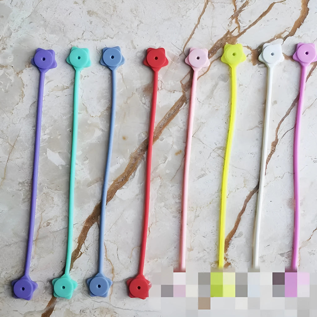 Small purple silicone wire winder with magnet for organising headphone cables.