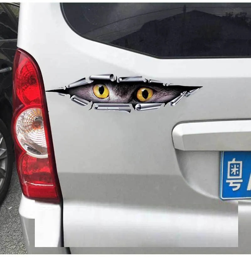 Close-up of a 3D transparent tiger eye car bumper sticker on a vehicle door.
