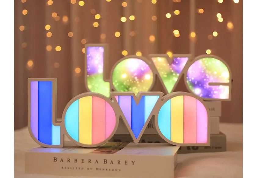 LED LOVE light with rainbow shade measuring 35.5cm, glowing softly on a wooden desk for Valentine's decoration.