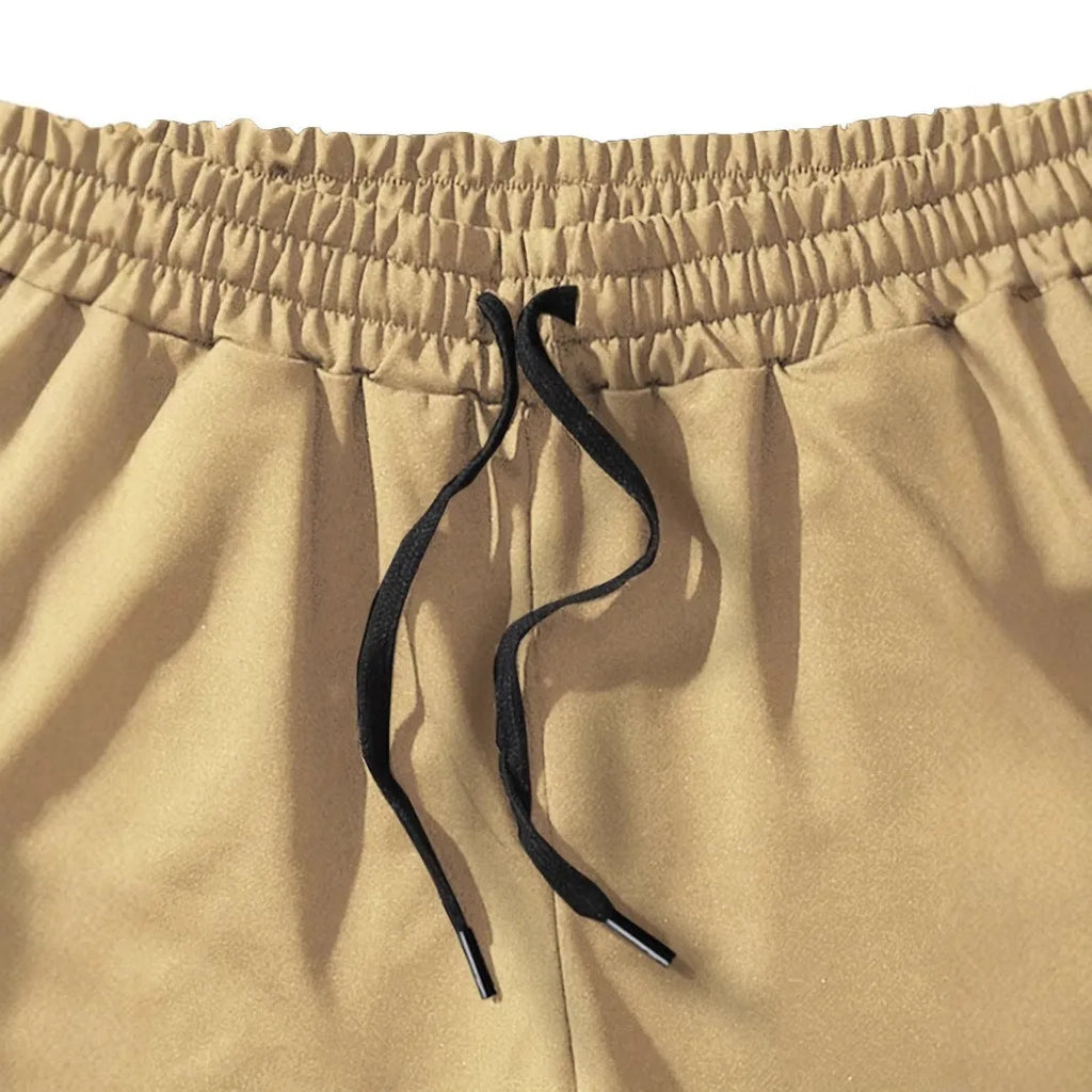 Khaki men's coconut print sports shorts with straight leg and elastic waistband