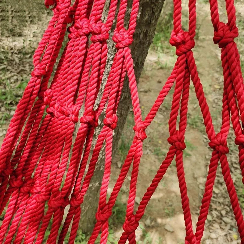 Outdoor nylon rope mesh hammock hung between two trees, showing its 1.1m width and included tying rope.