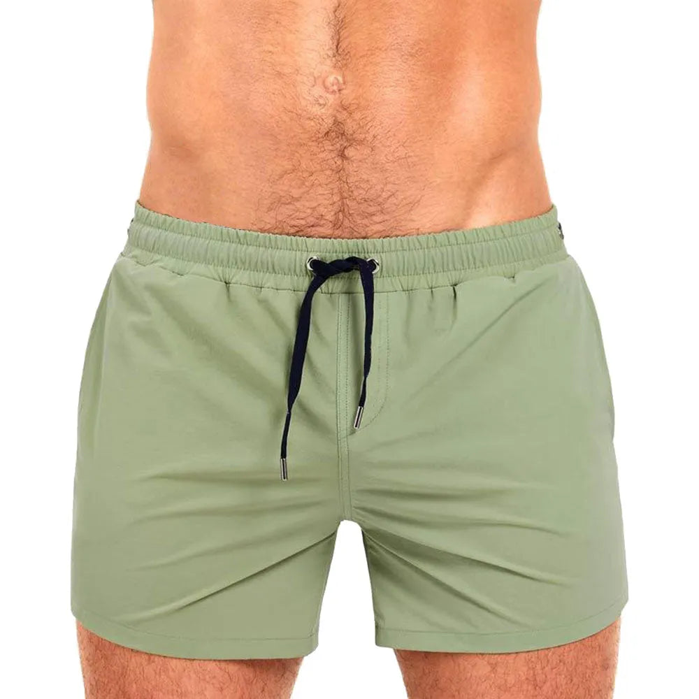 Man's solid colour polyester swimming shorts with mesh lining for sports and fitness.