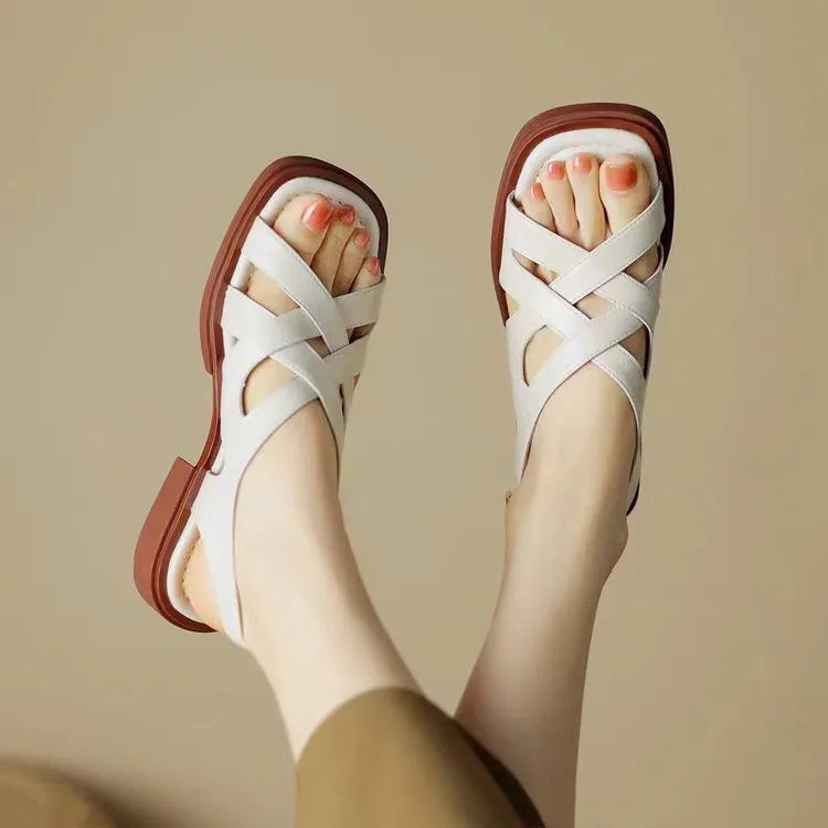Women's patent leather low heel square toe beach sandals in black colour with cross strap design