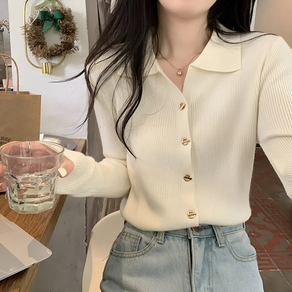 Long-sleeved beige viscose knitted cardigan top shown loose fit on a hanger
