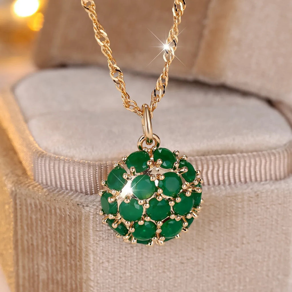 Round emerald and diamond necklace with adjustable chain in champagne gold