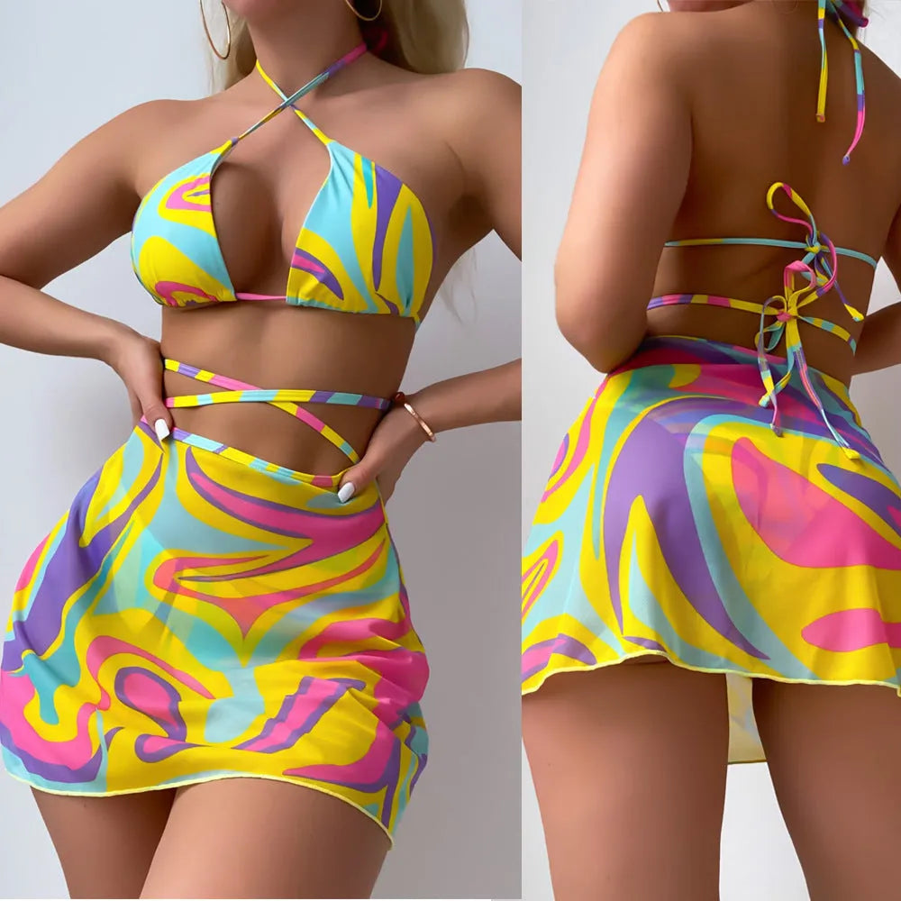 Yellow striped halter neck swimsuit with lace-up front, matching skirt, and shorts set for women.